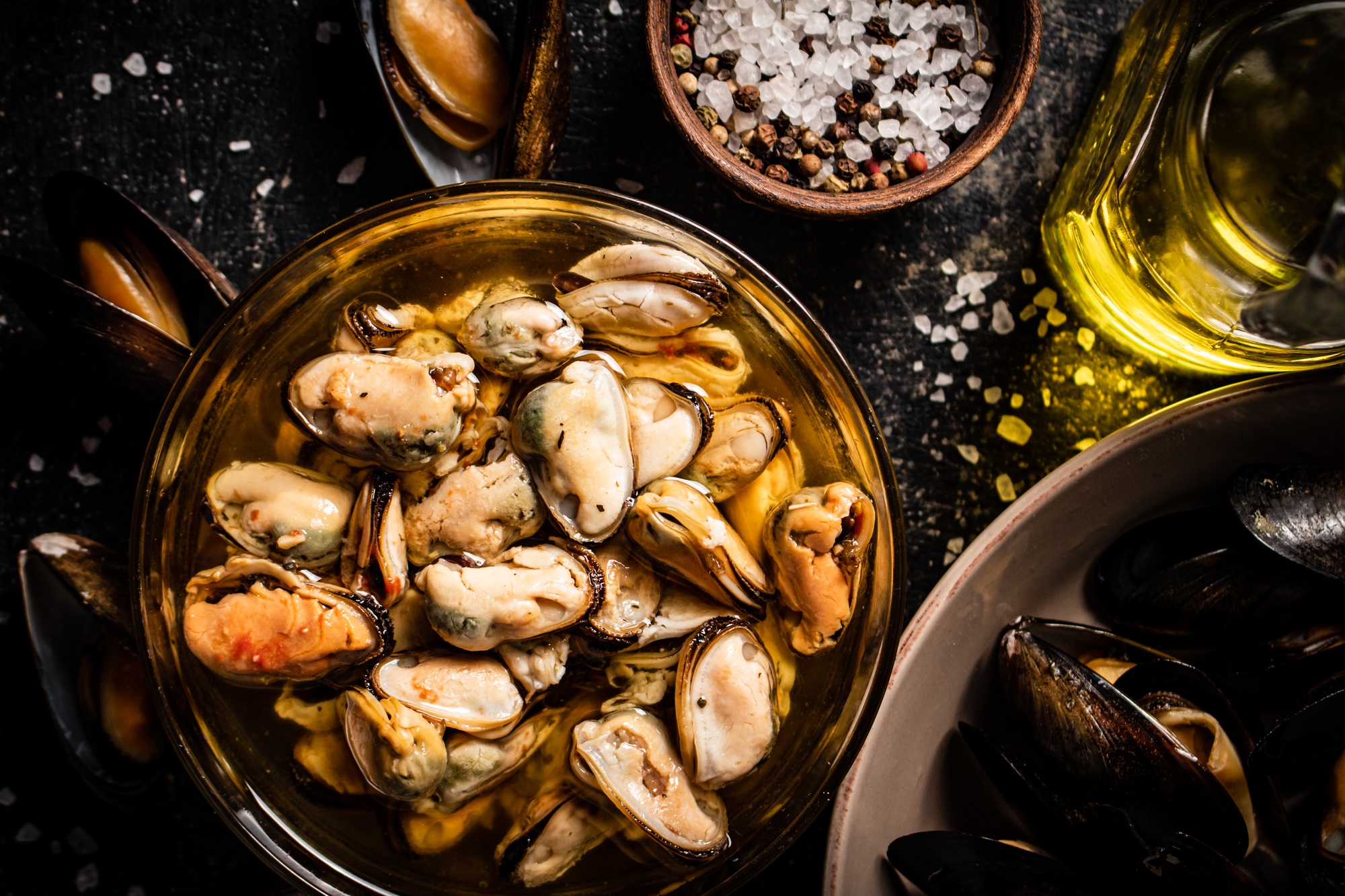 Pickled mussels in a glass bowl with spices.