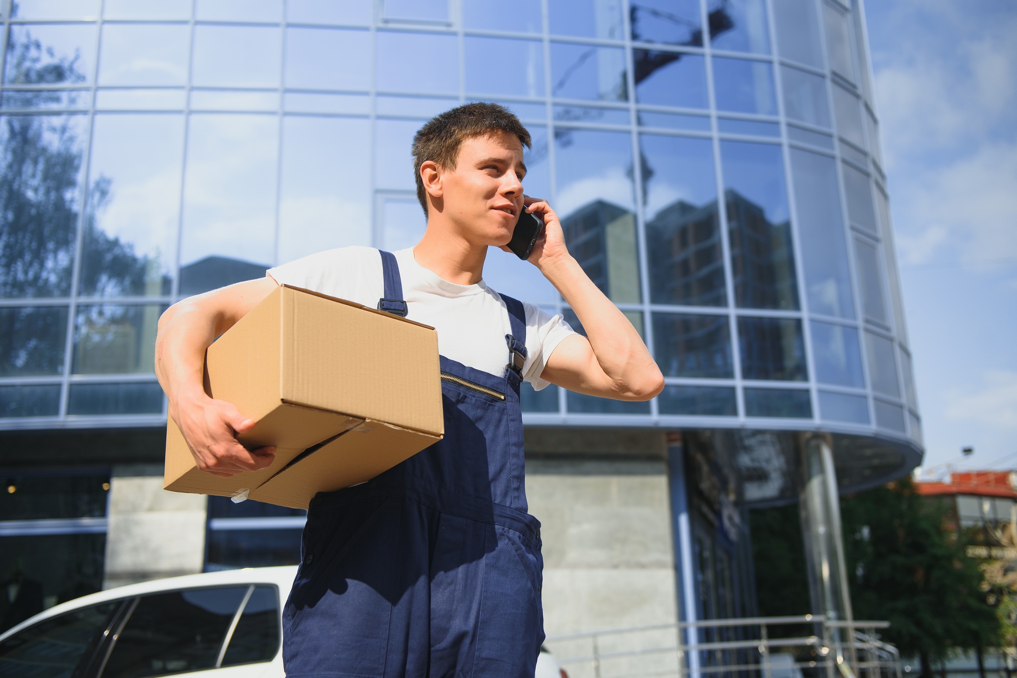Postman with parcel box. Postal delivery service.